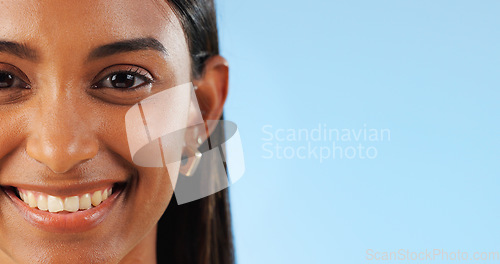 Image of Face, teeth whitening and dental, woman with smile for oral care and wellness on blue background. Beauty, hygiene and orthodontics with mockup space, portrait and healthy in studio with veneers