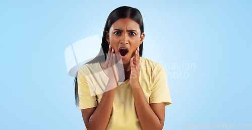 Image of Shock, surprise and woman in portrait in studio with reaction, facial expression and horror on blue background. Open mouth, wow for news or announcement, mockup space and gossip drama with mind blown