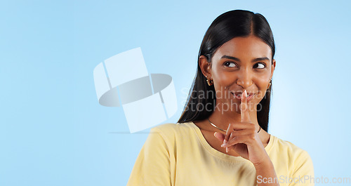 Image of Secret, gossip and woman with finger on lips, smile and announcement on a blue background. Person, girl and model with privacy, mockup space and drama news with surprise, emoji and whisper with shush