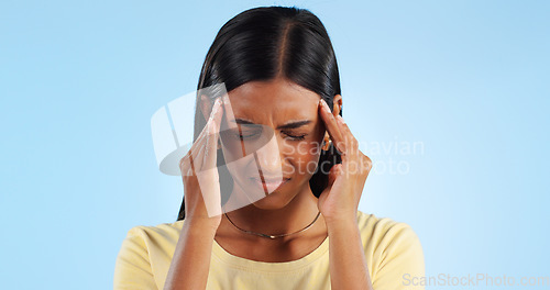 Image of Headache, pain and burnout, woman with fatigue in studio with health emergency and wellness on blue background. Migraine, brain fog and vertigo from medical condition with burnout, sick and tired