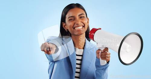 Image of Portrait, pointing to you and woman with a megaphone, business and motivation on a blue studio background. Face, person and consultant with a bullhorn, employee and support with announcement and news