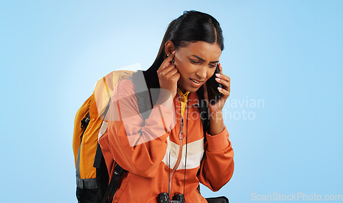 Image of Hiking studio, phone call problem and woman stress over trekking, backpacking and holiday travel crisis. Camper, smartphone communication fail or person with bad network connection on blue background