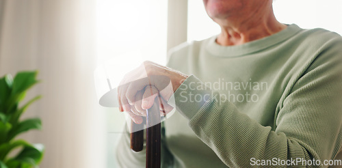 Image of Hands, old person with disability and walking stick, closeup with wellness and retirement. Senior care, cane to help with balance and support, Parkinson disease or arthritis, sick and health issue