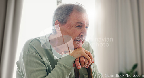 Image of Old man, thinking and walking stick, person with disability and remember with reflection at home. Senior care, cane to help with balance and support, Parkinson or arthritis with nostalgia and memory