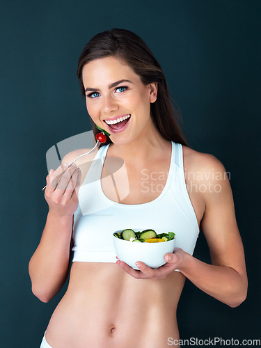 Image of Salad, woman eating and portrait with fitness, health and nutrition of meal with smile in studio. Workout, happy and female model with exercise and training with healthy food and vegetables for diet