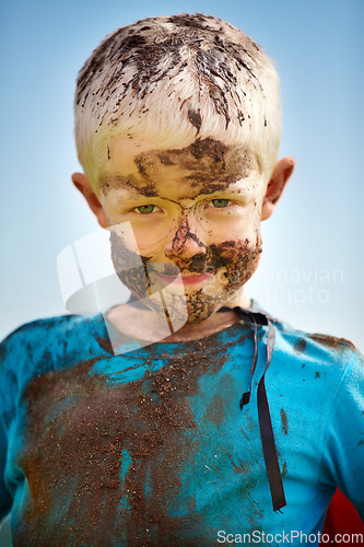 Image of Boy, child and mud on face with smile from playing, dirt or happiness in summer weather or water. Kid, person and portrait with satisfaction for messy or dirty fun outdoor in sunshine or garden