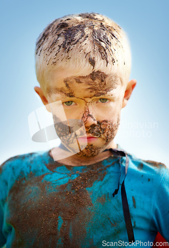 Image of Boy, child and portrait with mud on face from playing, dirt or naughty in summer weather or water. Kid, person or grime with satisfaction for messy or dirty fun outdoor in sunshine or garden with sky