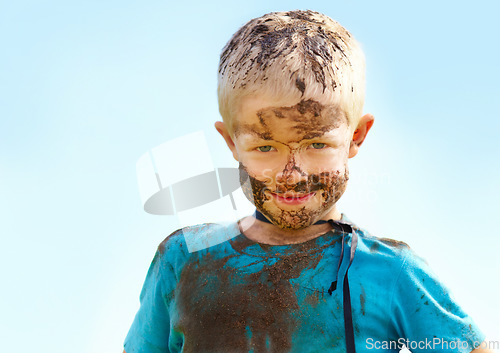 Image of Boy, kid and mud on face with smile from playing, dirt or happiness in summer weather or water. Child, person and portrait with satisfaction for messy or dirty fun outdoor in sunshine or garden