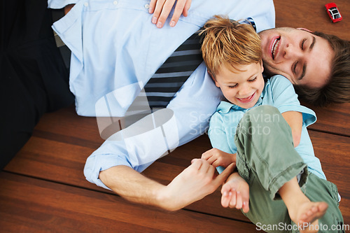 Image of Father, child and playing on floor with happy, family home and support of businessman with kid. Man, kid and game in freedom together to relax, trust and love in room with care, house and wellness
