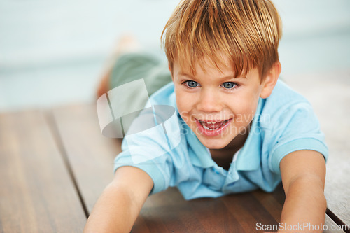 Image of Child, happy and playing game on floor in family home, security and learning with playing, growth and development. Boy, happiness and smile in living room for fun, care and excited in kindergarten