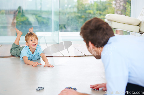Image of Father, child and playing on floor with toys, family home and happy with support of businessman. Man, boy or together to relax with smile, fantasy game and learning trust papa for love of cars
