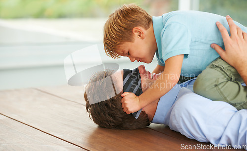 Image of Man, blindfold and game to play with child, living room floor or happy together by support of businessman. Papa, boy and smile in family home, fantasy and love with hug, care and tie on face