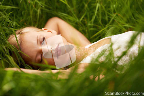 Image of Nature face, grass field and relax woman sleep, tired or leisure for outdoor wellness, calm wellbeing or countryside peace. Girl dream, freedom and park break with green lawn, pitch or garden growth