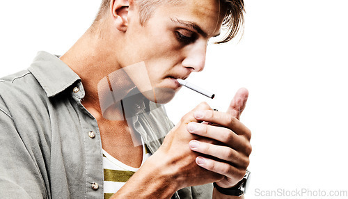 Image of Stress, studio and man lighting a cigarette with a lighter to smoke for an addiction or habit to relax. Dangerous, smoker or person from Germany smoking tobacco isolated by a white background alone