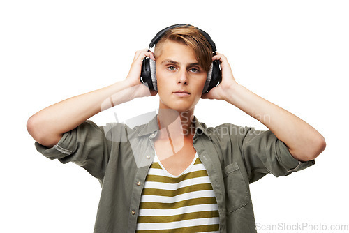 Image of Man, portrait and DJ with headphones listening to music for audio streaming against a studio background. Young male person or sound artist with headset for podcast, beats or radio track on mockup