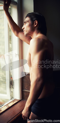 Image of thinking, home or man in underwear for fitness in bodybuilding workout, training or exercise. Topless model, bodybuilder or thoughtful person by window with shadow, ideas or body muscle for wellness