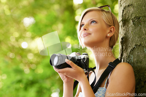 Image of Happy, woman and photographer in nature with trees, camera and vacation in environment. Forest, park and girl filming with natural happiness outdoor on summer holiday, trip or travel with technology
