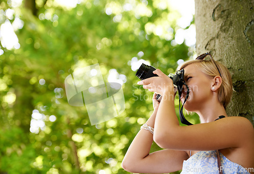 Image of Woman, photographer and shooting in nature with trees, camera and memory of environment mockup. Spring, park and freelancer filming forest outdoor on summer holiday, trip or travel with technology