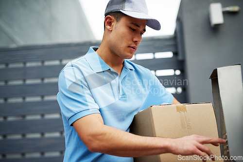 Image of Box, entrance or doorbell with a delivery guy by home for entrance for online shopping or product. Apartment, button press or courier man by buzzer to enter a house for ecommerce service or package