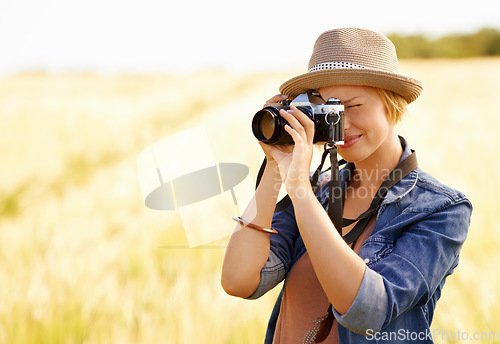 Image of Woman, camera and photography with safari, vacation and holiday with wheat field and plants. Nature, photographer and outdoor with traveler blog and countryside with photo for adventure and journey