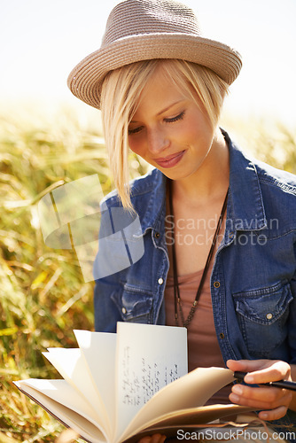 Image of Nature woman, field and reading book, journal or diary about spring wellness, travel lifestyle or creative story. Notebook letter, creativity and person review notes, summer planner or information