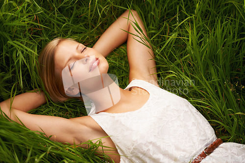 Image of Nature field, grass and relax woman sleep, tired or leisure for summer sunshine, outdoor wellness or countryside rest. Girl dream, freedom and park break on natural green lawn, pitch or spring garden