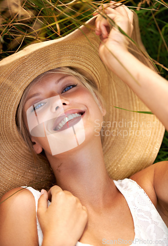 Image of Summer, hat and portrait with woman in field for travel, vacation and holiday. Smile, peace and nature with female person and grass in countryside meadow for calm environment, spring and sunshine