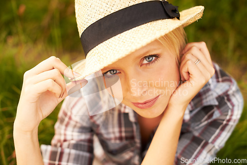 Image of Smile, portrait and young woman in nature with a straw hat sitting in an outdoor garden for fresh air. Happy, fashion and female person from Australia in the forest, woods or field with casual style.