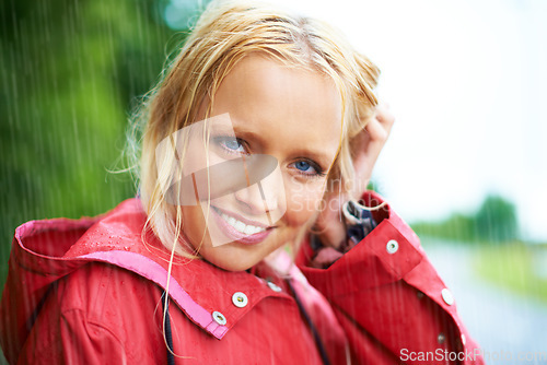 Image of Smile, portrait and young woman in the rain with coat in nature, road or street for winter. Happy, positive attitude and female person from Australia in drizzle or storm weather in outdoor forest.