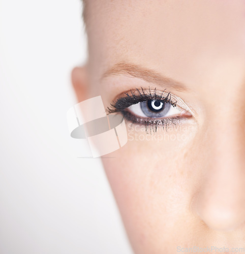 Image of Beauty, eye and half portrait of woman with natural makeup, facial spa treatment and aesthetic dermatology in studio. Vision, skin care and face of model with light, wellness and white background.