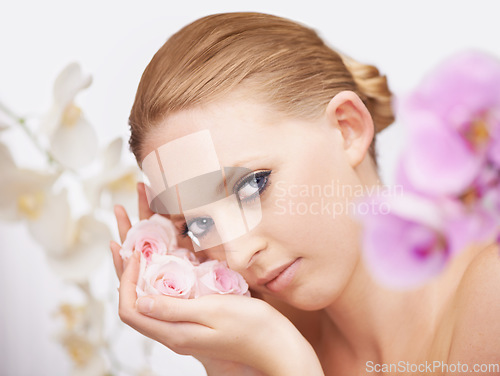 Image of Beauty, flowers and portrait of woman for facial spa treatment and special floral aesthetic in studio. Boho fashion, skincare and face of model with roses, wellness and salon dermatology with nature.