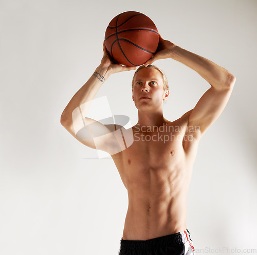 Image of Basketball, shirtless and man with exercise, health and training on a white studio background. Person, model or athlete with competition, topless or muscle with workout, talent or player with fitness