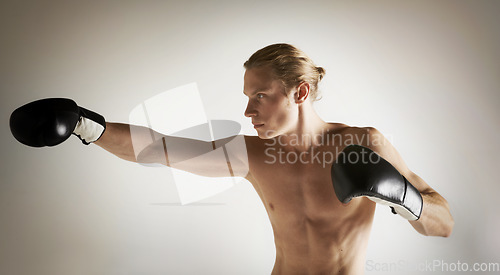 Image of Fighting, boxing and shirtless with man, training and exercise with health on a studio white background. Person, guy and professional with competition, practice for a match and muscle with workout