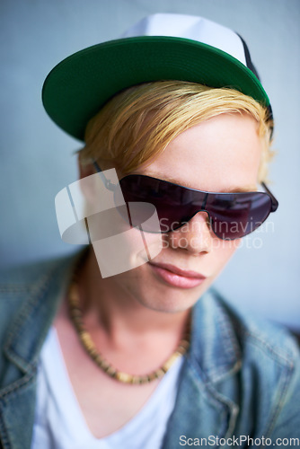 Image of Fashion, sunglasses and a cool young boy in studio on a gray background for trendy youth style. Portrait, children and attitude with a confident kid in shades to wear an outfit as a teenage youngster