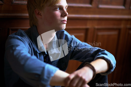 Image of Thinking, depression and an unhappy boy student at school as an outcast feeling lonely in a classroom. Education, scholarship and a sad young child in a class looking bored while alone on campus