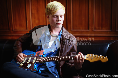 Image of Music, artist and young man with guitar for artistic, creative and musical career with talent. Guitarist, musician and male person playing an electric string instrument for recording in a studio.
