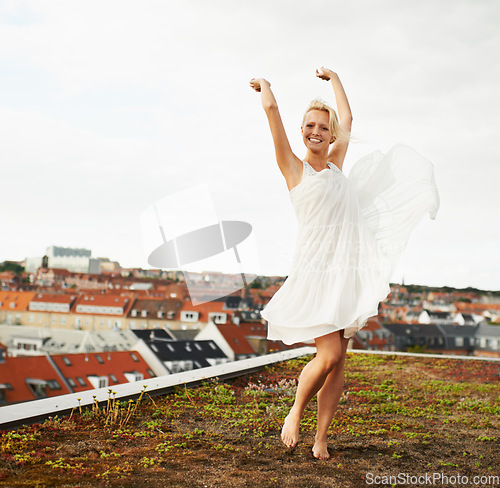 Image of Woman, happiness and dancing on rooftop, carefree and outdoor with freedom, smiling and city. Wind, dancer and urban area for break, summer and smile on trip, barefoot and amsterdam spring time