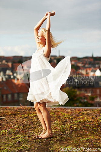 Image of Woman, happiness and dancing on vacation, summer and outdoor for holiday, smiling and city. Wind, dancer and urban area for break, getaway and carefree on trip, barefoot and amsterdam spring time