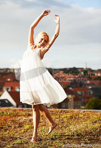 Image of Woman, joyful and dancer on vacation, summer and outdoor for holiday, smiling and dress. Rooftop, dancing and urban area for break, getaway and carefree on skyline, barefoot and amsterdam spring time