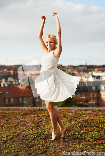 Image of Woman, spinning and dancing on carefree, holiday and outdoor for vacation, smiling and city. Wind, dancer and urban area for break, getaway and carefree on trip, barefoot and amsterdam spring time