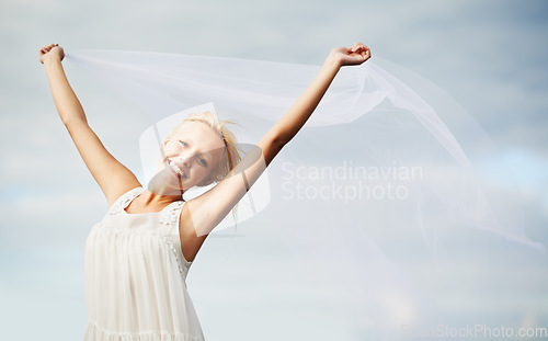 Image of Portrait, happy and woman with chiffon in wind outdoor for summer, vacation or travel on holiday. Face, smile and dress or fabric fly for freedom, beauty and elegant, fashion or glamour on blue sky
