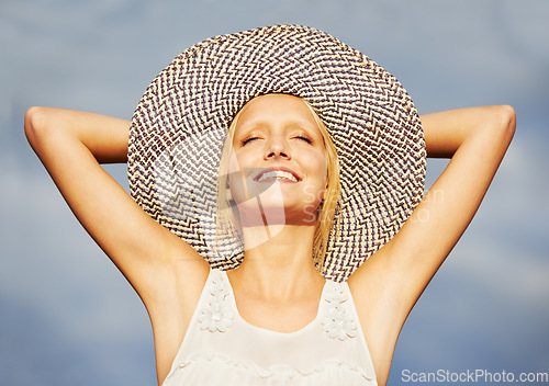 Image of Woman, sun hat or summer blue sky for vacation holiday bliss, tropical island or smile travel. Female person, beach cap or arms up for outdoor happy or relax rest trip, satisfaction or warm weather