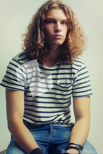 Image of Tshirt, jeans and portrait of man with fashion in studio background with gen z college student. Casual, style and person with indie, hipster or stylish model at university campus and backdrop