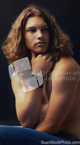 Image of Man, shirtless and beauty with hair in studio, curls and shine with model on dark background. Young, fit and gen z, muscle and skin with cosmetics, hipster casual and calm with curly hairstyle