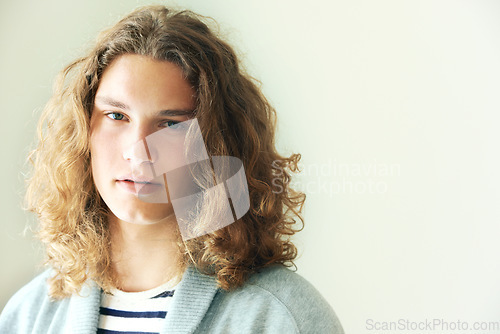 Image of Long hair, man or fashion for portrait on mockup space in studio in hipster style clothing on white background. Face, person or headshot of stylish gen z male model with cool confidence and pride