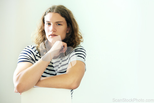 Image of Studio, portrait and man relax with arms crossed in salon for haircare, dermatology or beauty in white background. Calm, person and thinking about damaged, frizzy hair or treatment for hairstyle