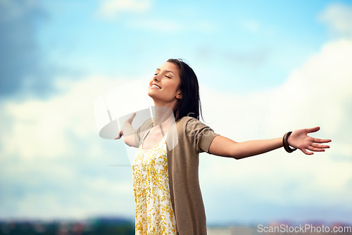 Image of Woman, arms spread and happy on rooftop, adventure and freedom on trip to Norway, joy and sky background. Female person, vacation and relax or positive for getaway, energy and stretching in holiday