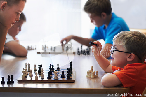 Image of Students, chess and playing in a classroom, conversation and thinking with solution, problem solving and competition. Youth, group or boys with tournament, board game and strategy with skills or talk