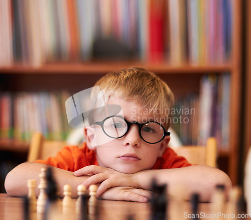 Image of Portrait, chess and boy with glasses, bored and competition with training, skills and clear vision. Face, person or kid with eyewear, tournament or game with thinking, contemplation, ADHD or solution