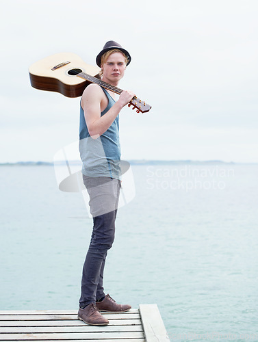 Image of Lake, nature and portrait of man with guitar, inspiration on journey, freedom and outdoor vacation. Artist, musician or guitarist with creative holiday, music and travel adventure with calm water.